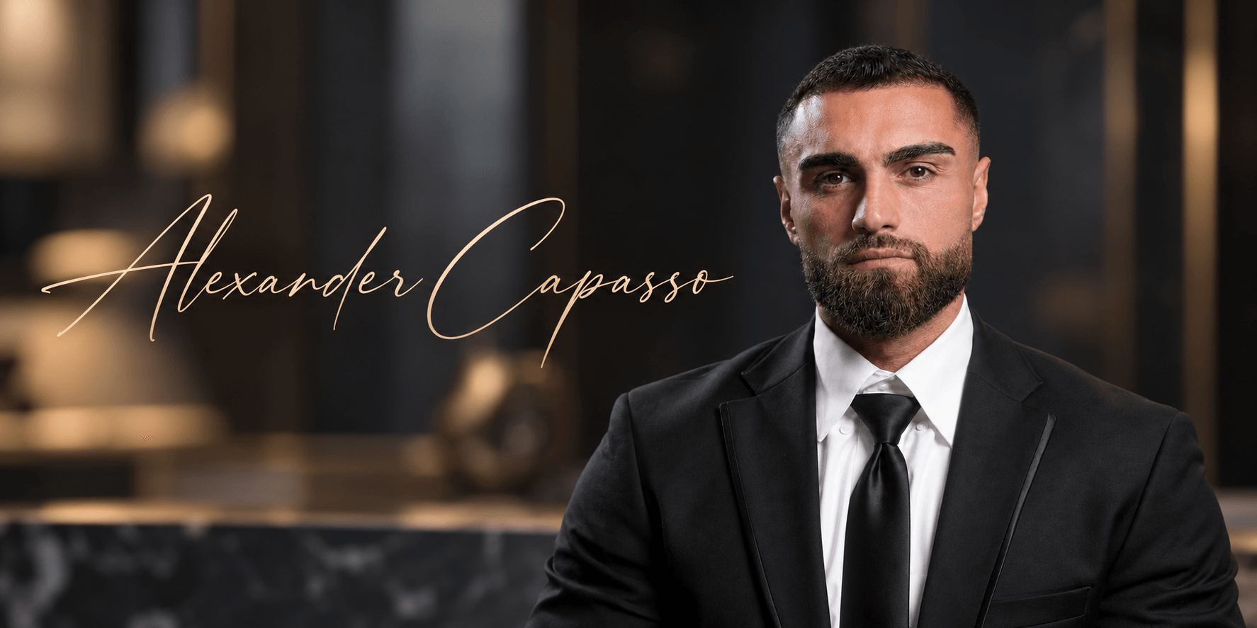 A well-dressed man with a beard sits confidently in a luxurious setting