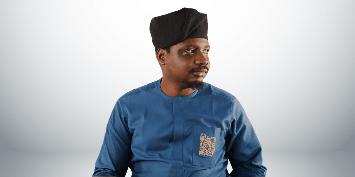 Man wearing a traditional outfit with a black cap, looking to the side