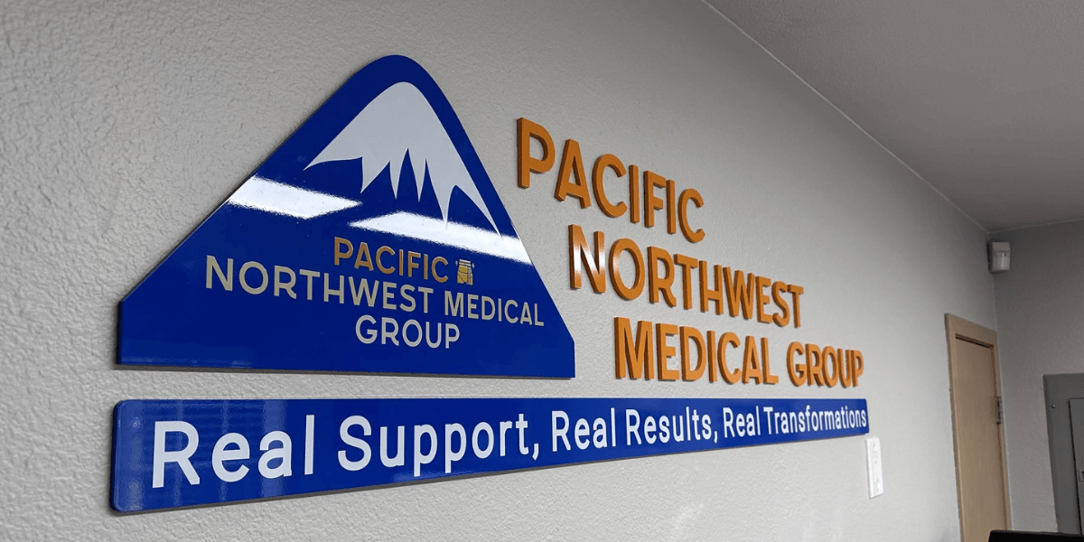 Sign displaying "Pacific Northwest Medical Group" with a mountain logo and slogan underneath