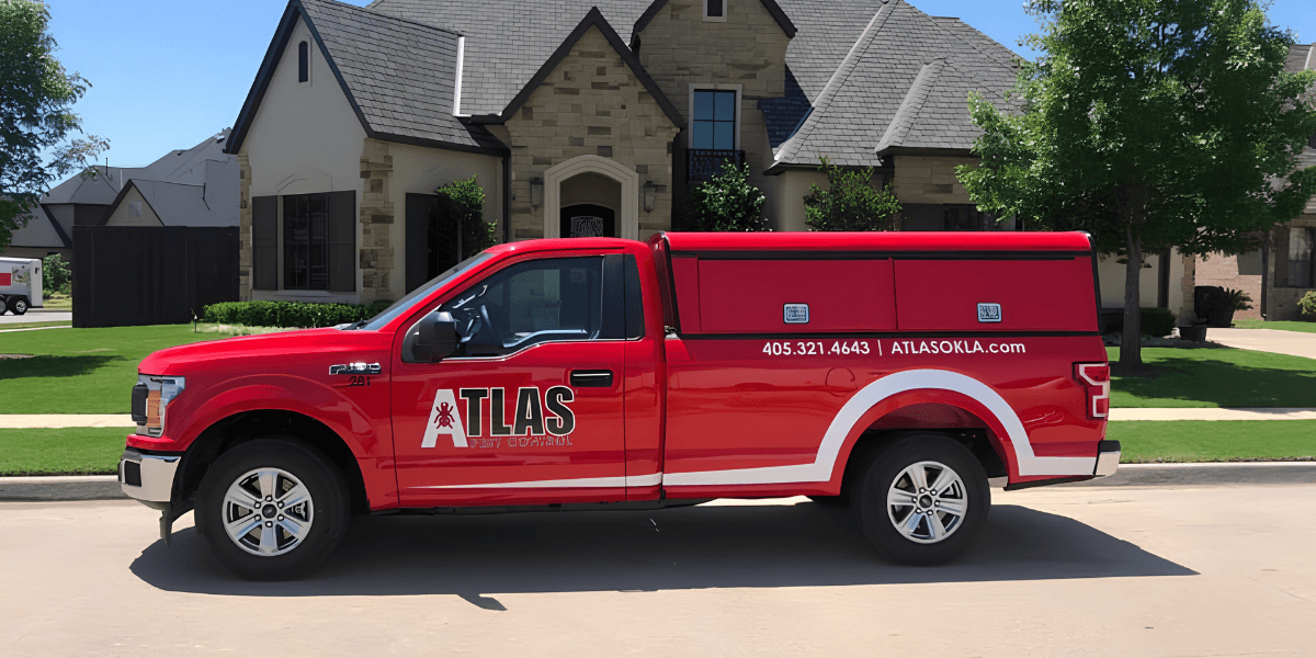Red pickup truck with "ATLAS" branding parked in a residential area.