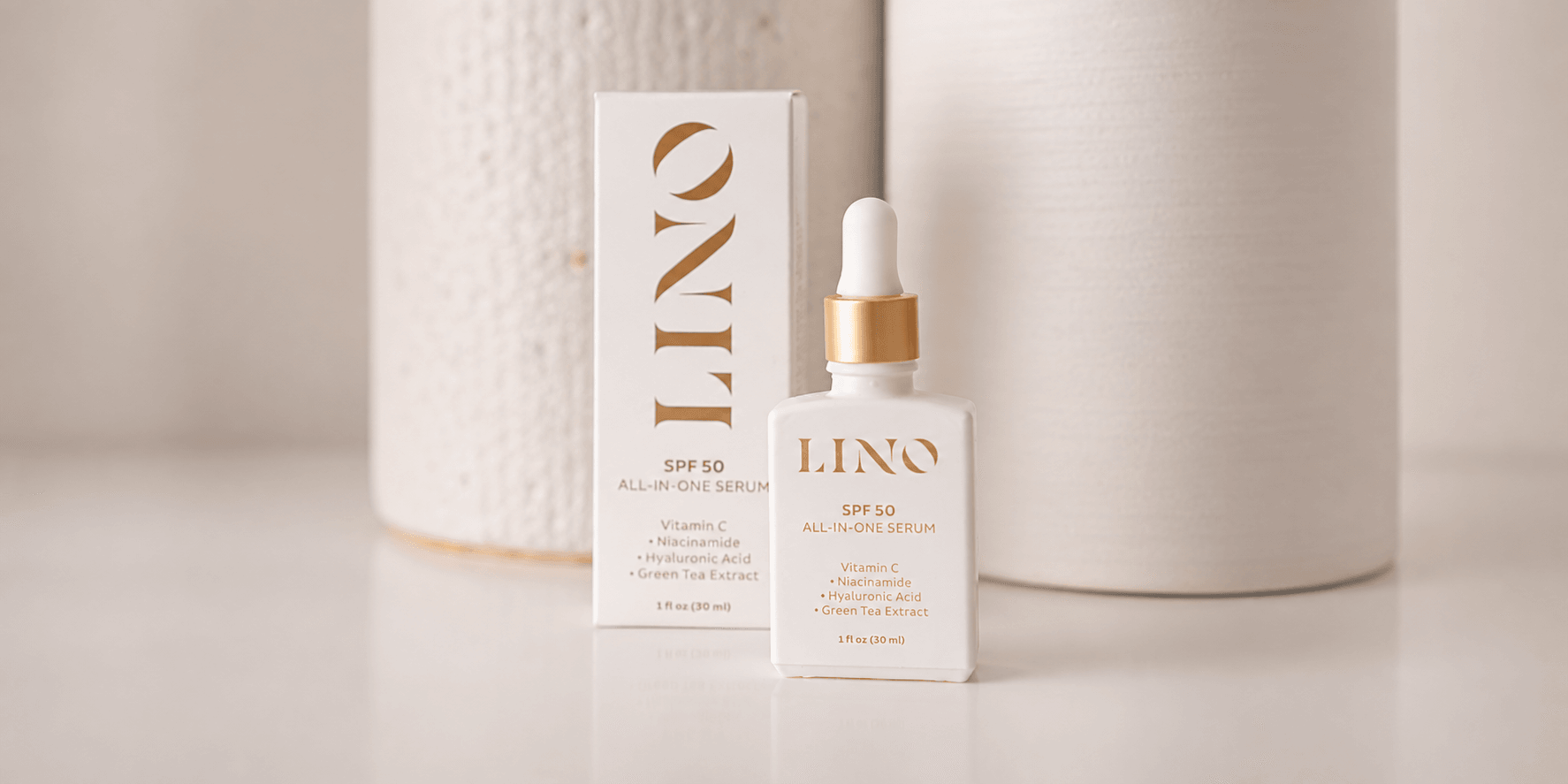 White serum bottle with dropper and sleek packaging against a neutral background