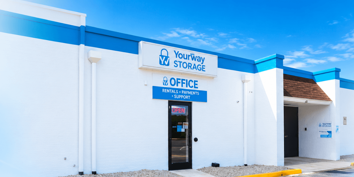 Exterior of YourWay Storage facility with blue accents and an open sign.