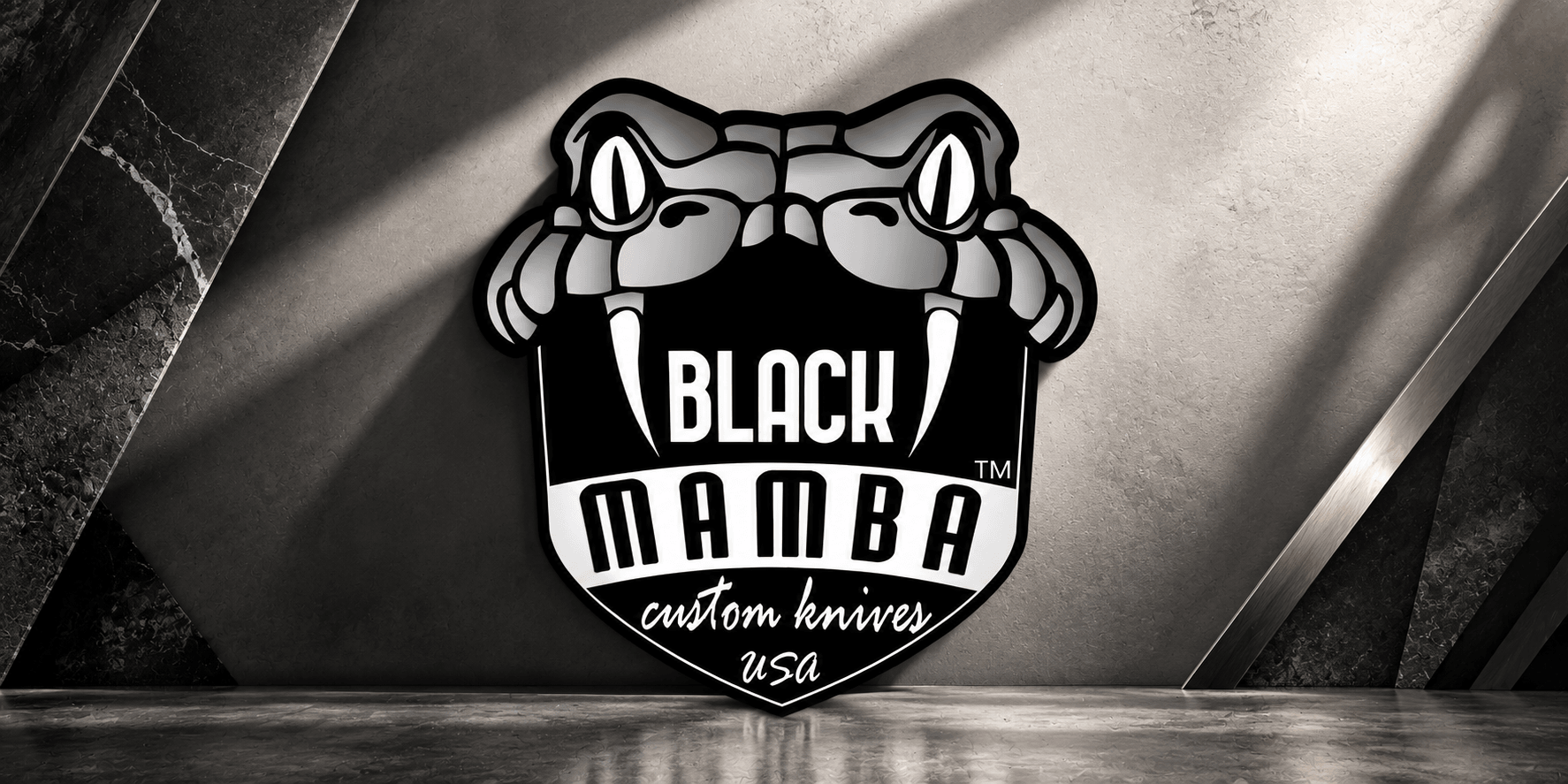 Logo of Black Mamba custom knives featuring a snake design and bold typography