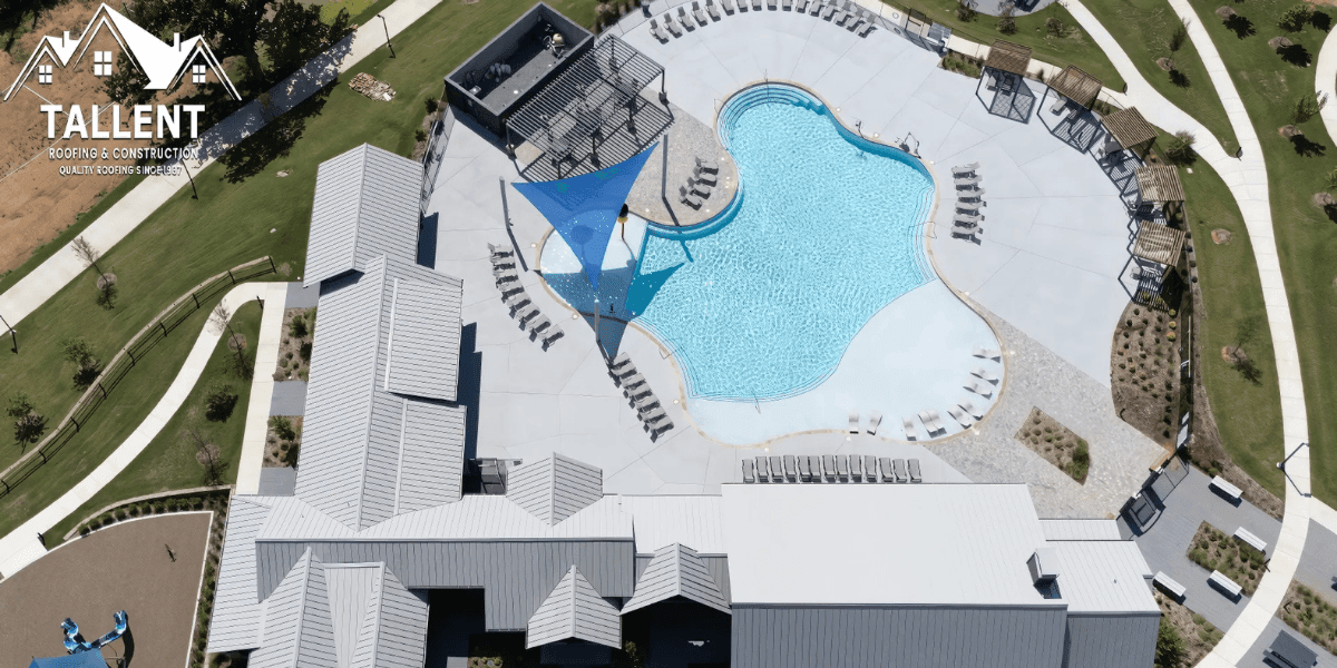 The image shows the Foree Ranch Amenity Center with a modern pool and a well-maintained roofing system by Tallent Roofing.