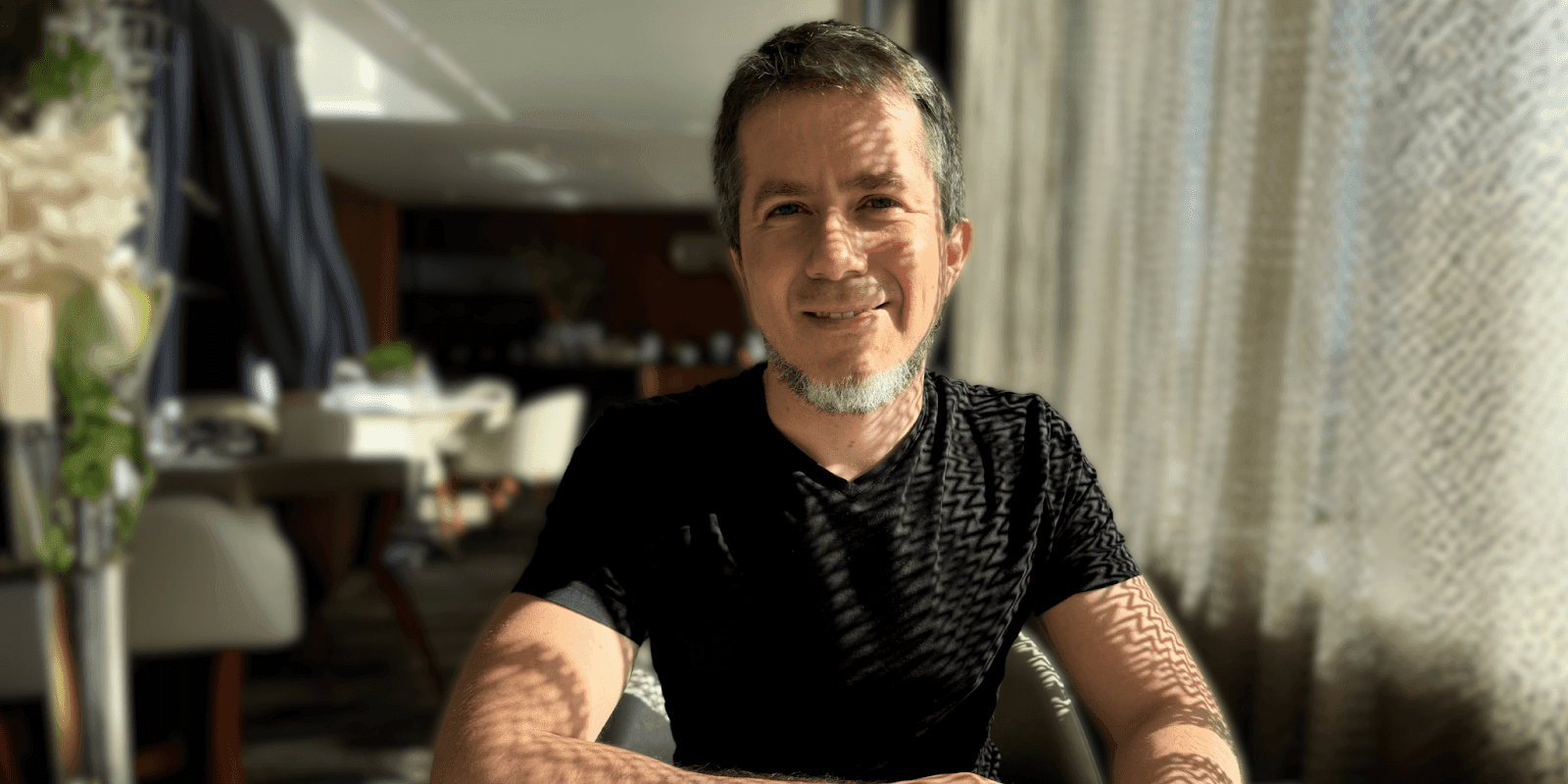 Tiz Gambacorta smiling, seated in a modern space, embodying his transition from fintech to AI-powered venture capital.