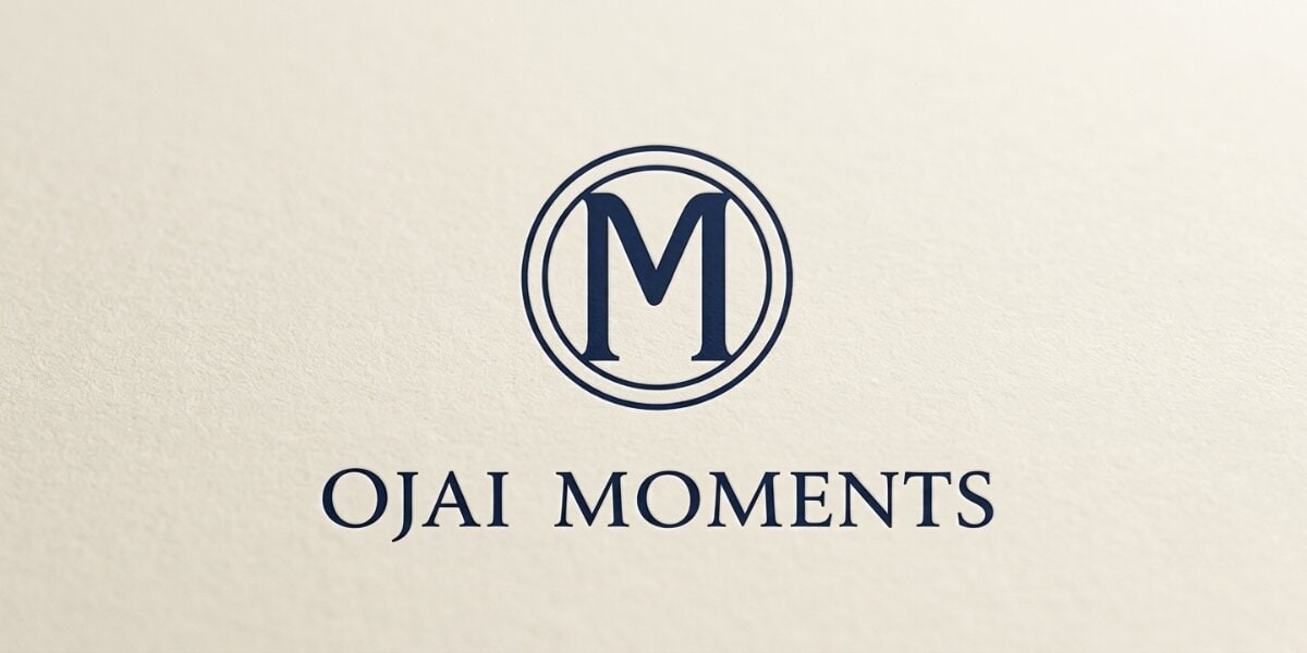 Ojai Moments logo displayed on a textured light background, featuring a stylized “M” emblem.