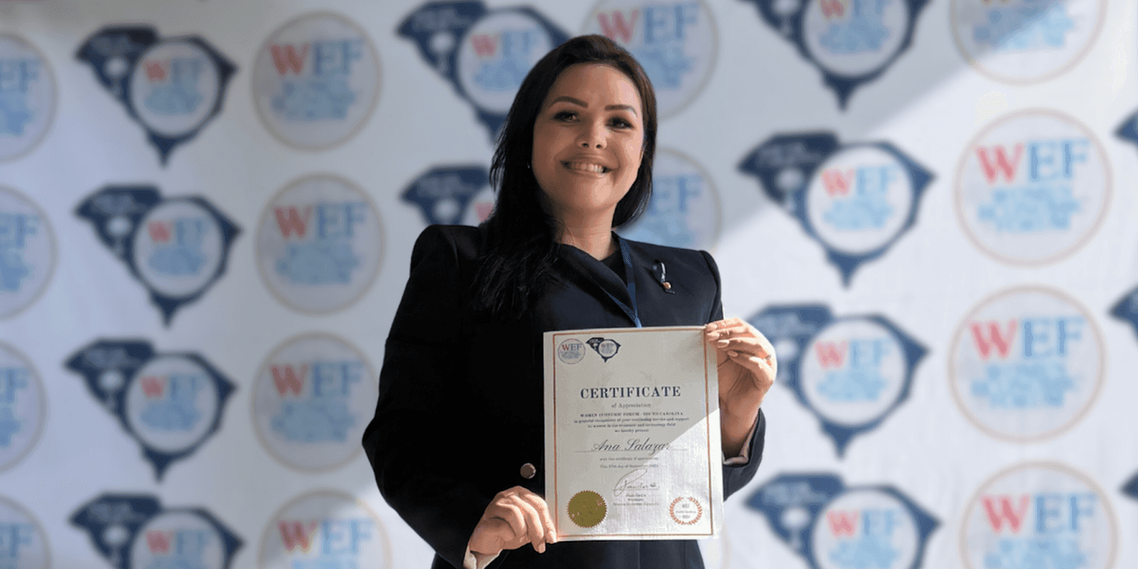 Ana V. Salazar proudly holds her Certificate of Appreciation at the Women Economic Forum, highlighting her leadership in intellectual property.
