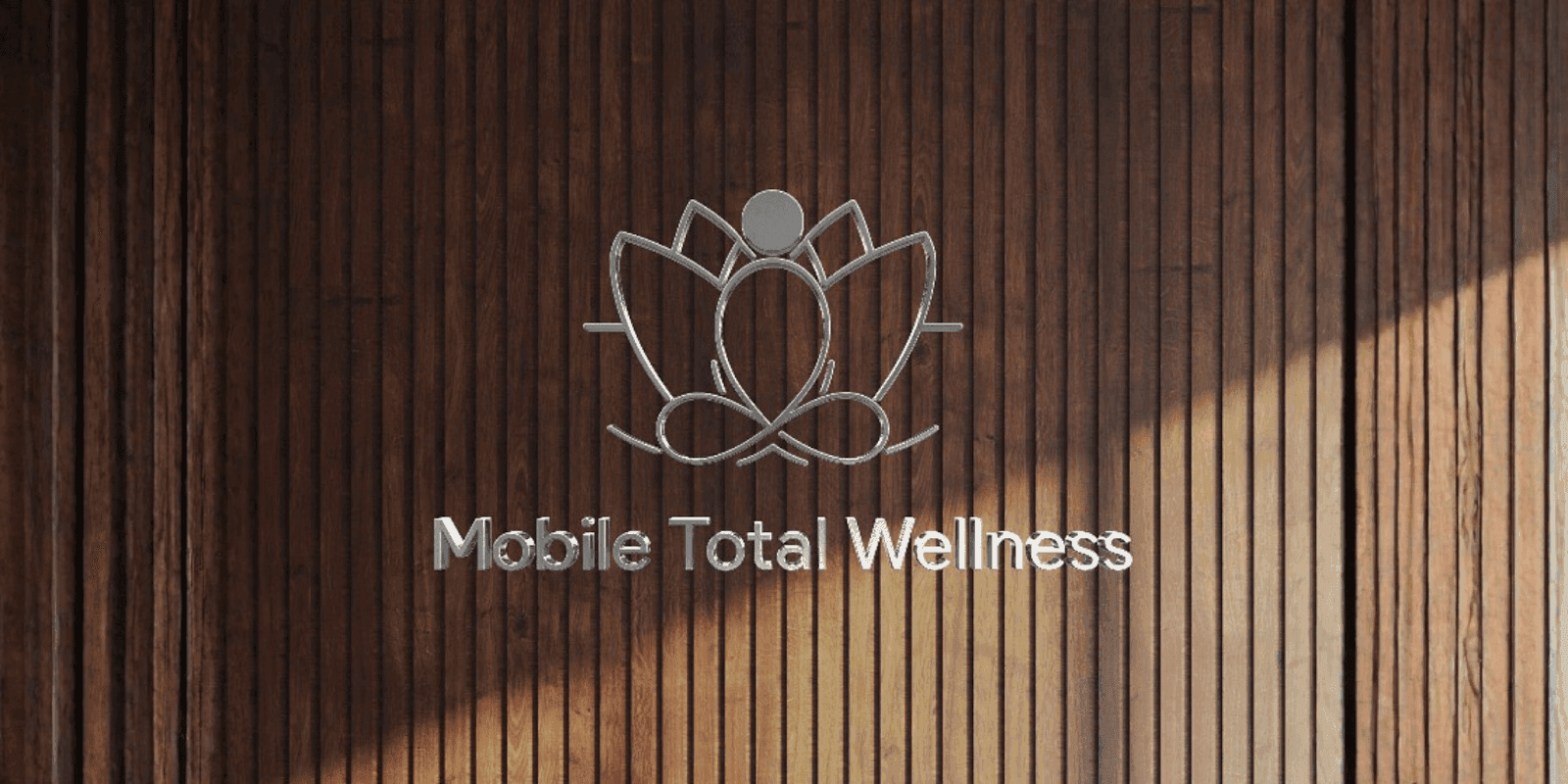 Mobile Total Wellness logo on wooden wall representing holistic health, mental wellness, and aesthetic care integration.