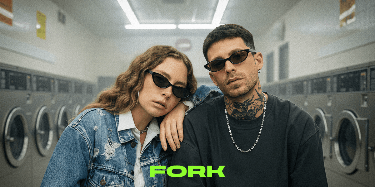 Two people wearing stylish FORK sunglasses in a laundromat, showcasing nightlife-inspired fashion by Optimax Eyewear Group.
