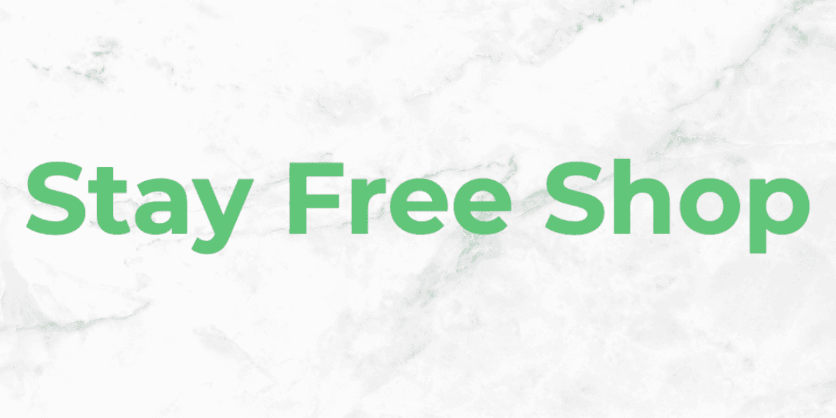 Stay Free Shop logo displayed with bold green text on a marble background.