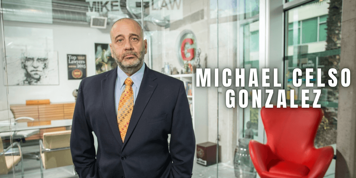 "Portrait of Michael Celso Gonzalez in a business suit standing in a modern office lobby with the text 'MICHAEL CELSO GONZALEZ' on the right side of the image."