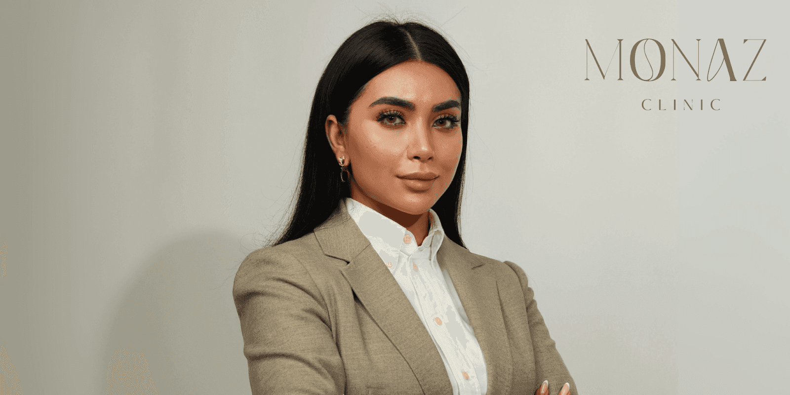 Portrait of Mona Zirak, founder of Monaz Clinic, showcasing elegance and professionalism in a beige suit on Harley Street.