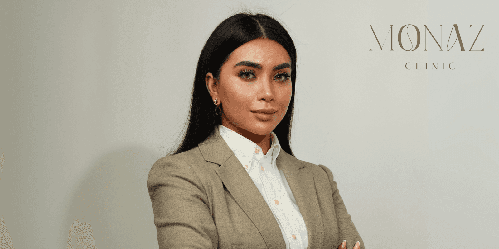 Portrait of Mona Zirak, founder of Monaz Clinic, showcasing elegance and professionalism in a beige suit on Harley Street.