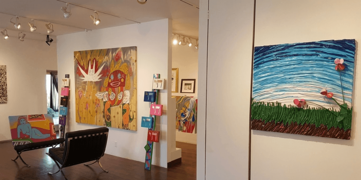 An art gallery showcasing bright, uplifting paintings on the walls, embodying the philosophy of "happy art."