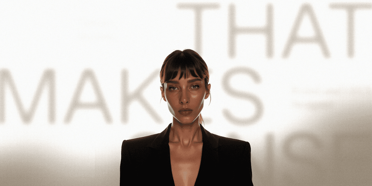 Tamara Abramia in a black suit, with a blurred background featuring the phrase "That Makes Sense."
