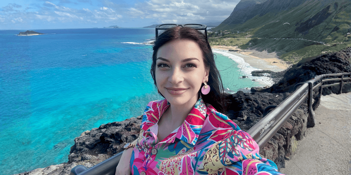 Marija Farfán smiles near the ocean, embodying her journey of success, faith, family, and work-life balance.