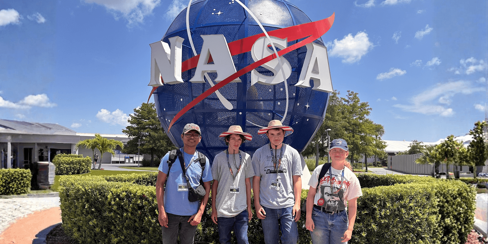 A group of students stands outside NASA's Kennedy Space Center, showcasing hands-on science learning and STEM exploration opportunities.