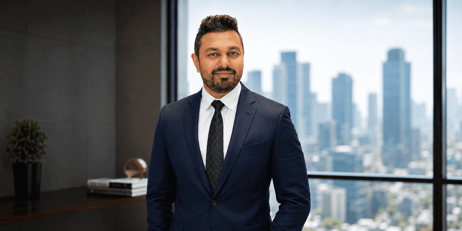Dr. Mayur Ghule standing in a business suit with a city skyline in the background.