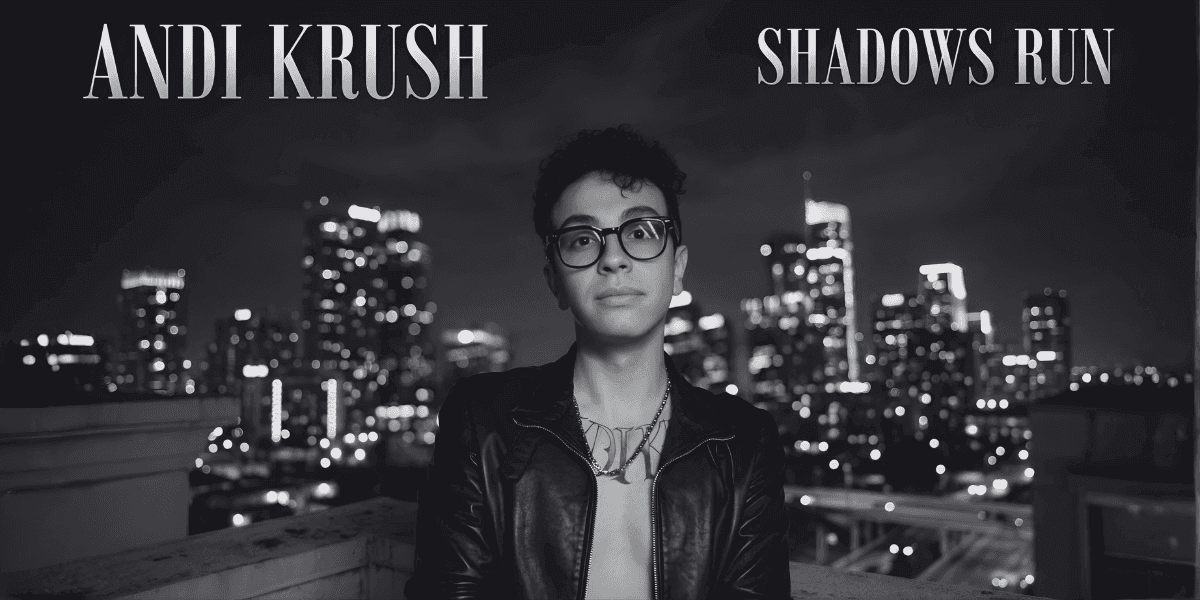 Black-and-white portrait of artist on rooftop with city skyline; text “Andi Krush” and “Shadows Run.”