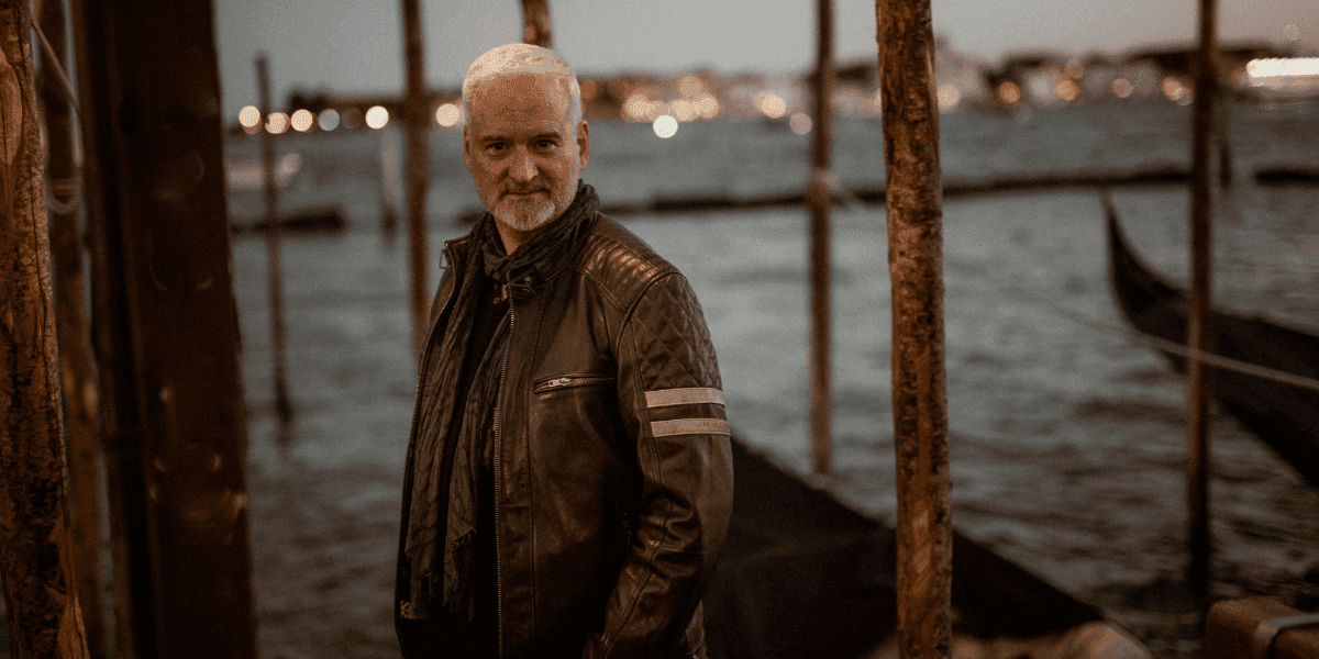 Richard Knight standing beside Venice canals at dusk, reflecting his professional presence and contemporary Tarot teaching.