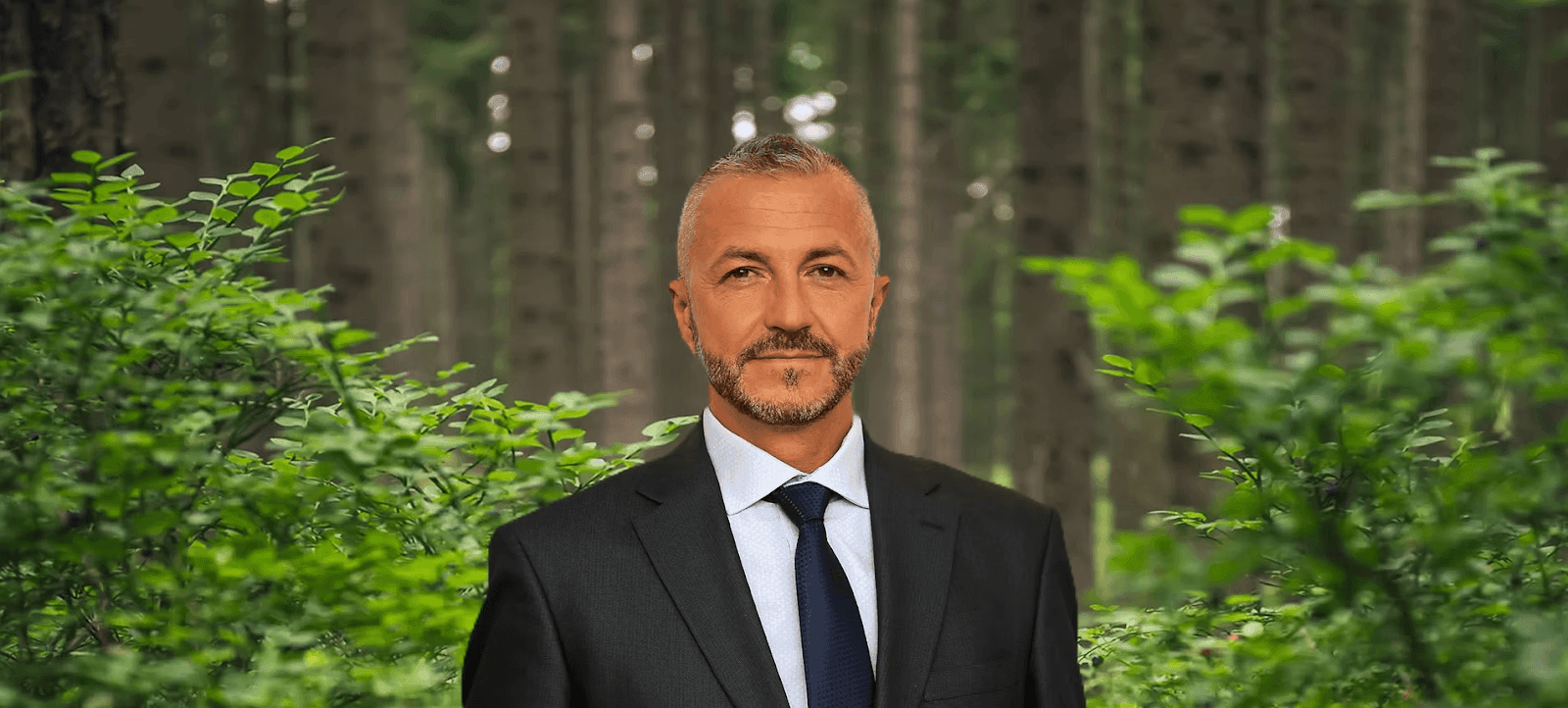 Mahir Zisko Sukalic, founder of Illyricum Investments, stands in a lush forest, symbolizing the vision for Illyricum City.