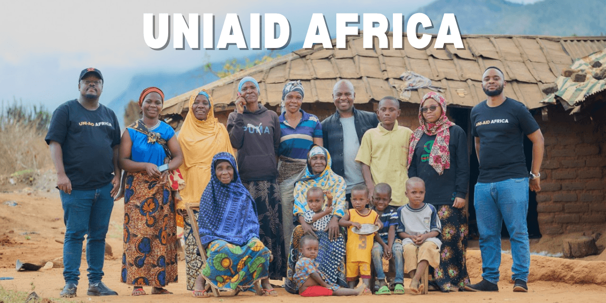 "UNIAID Africa team members with local families in rural Tanzania, showing support for community development and education initiatives."