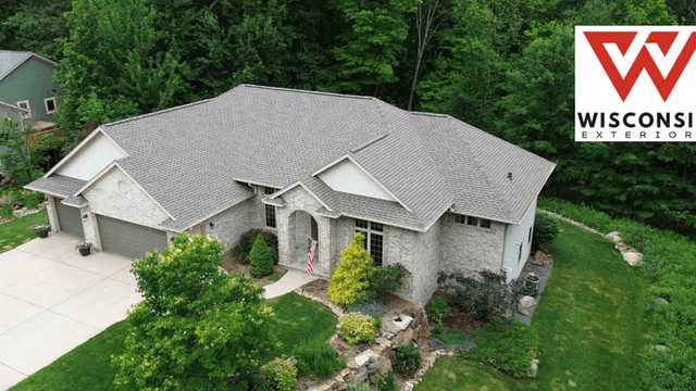 Aerial view of a modern home with landscaping and a Wisconsin Exteriors logo