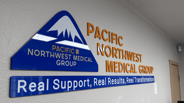 Sign displaying "Pacific Northwest Medical Group" with a mountain logo and slogan underneath