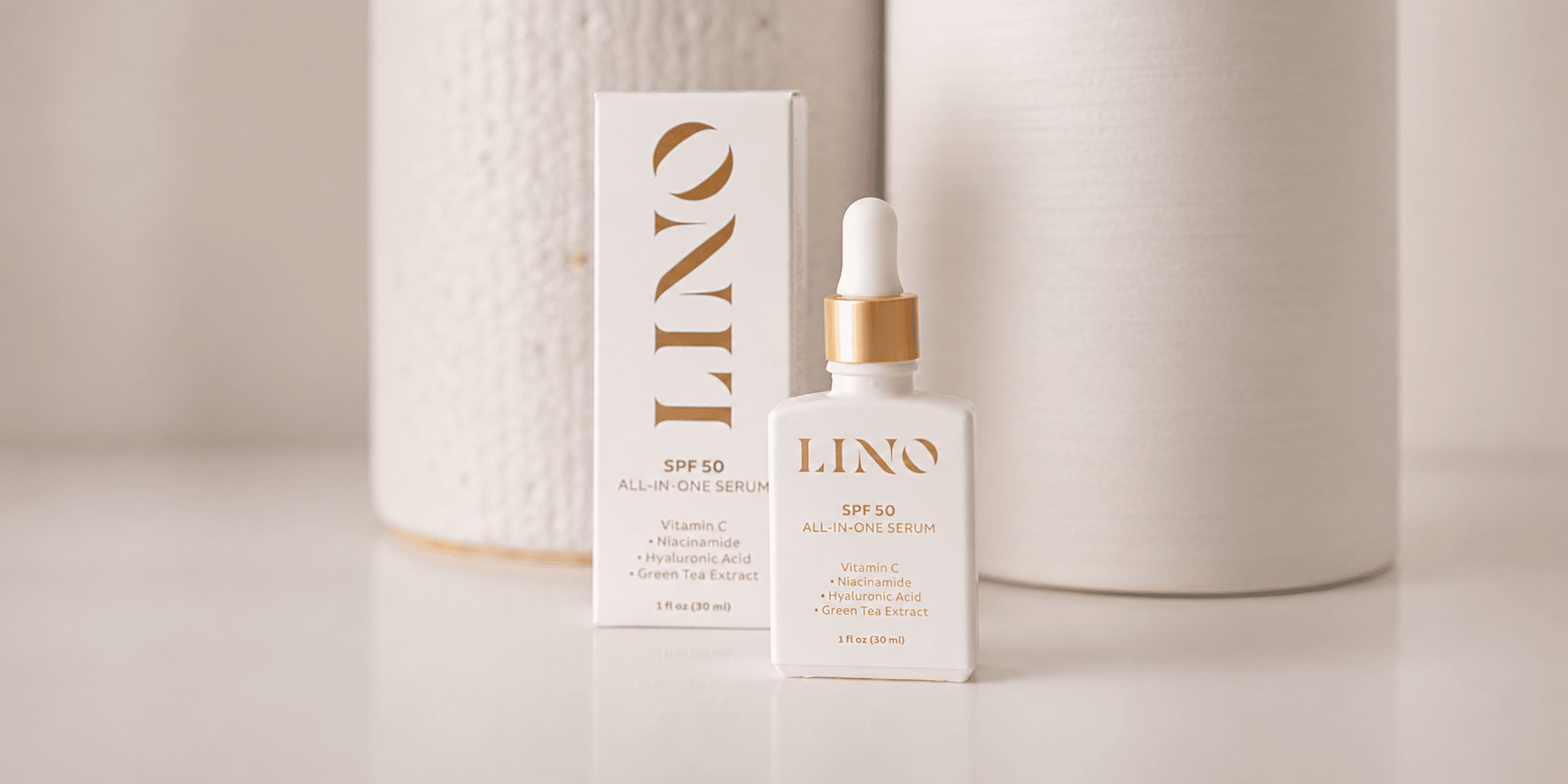 White serum bottle with dropper and sleek packaging against a neutral background