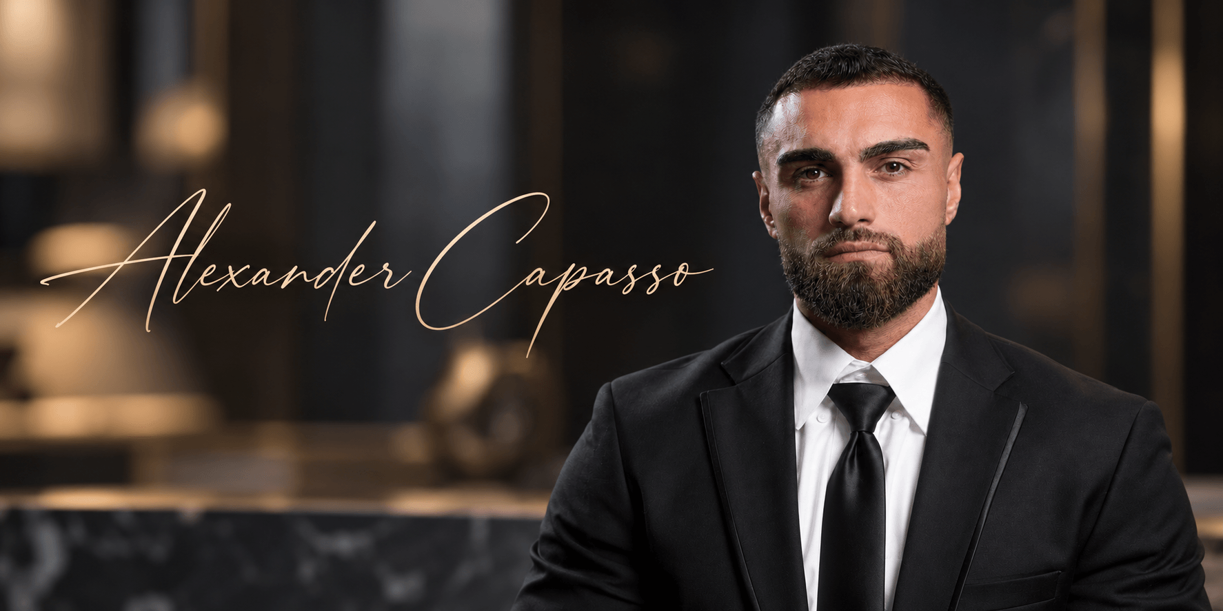 A well-dressed man with a beard sits confidently in a luxurious setting