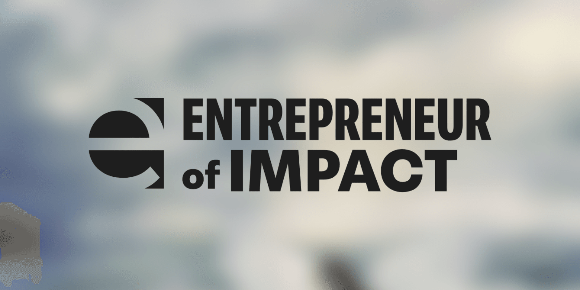 Logo for Entrepreneur of Impact with a blurred background