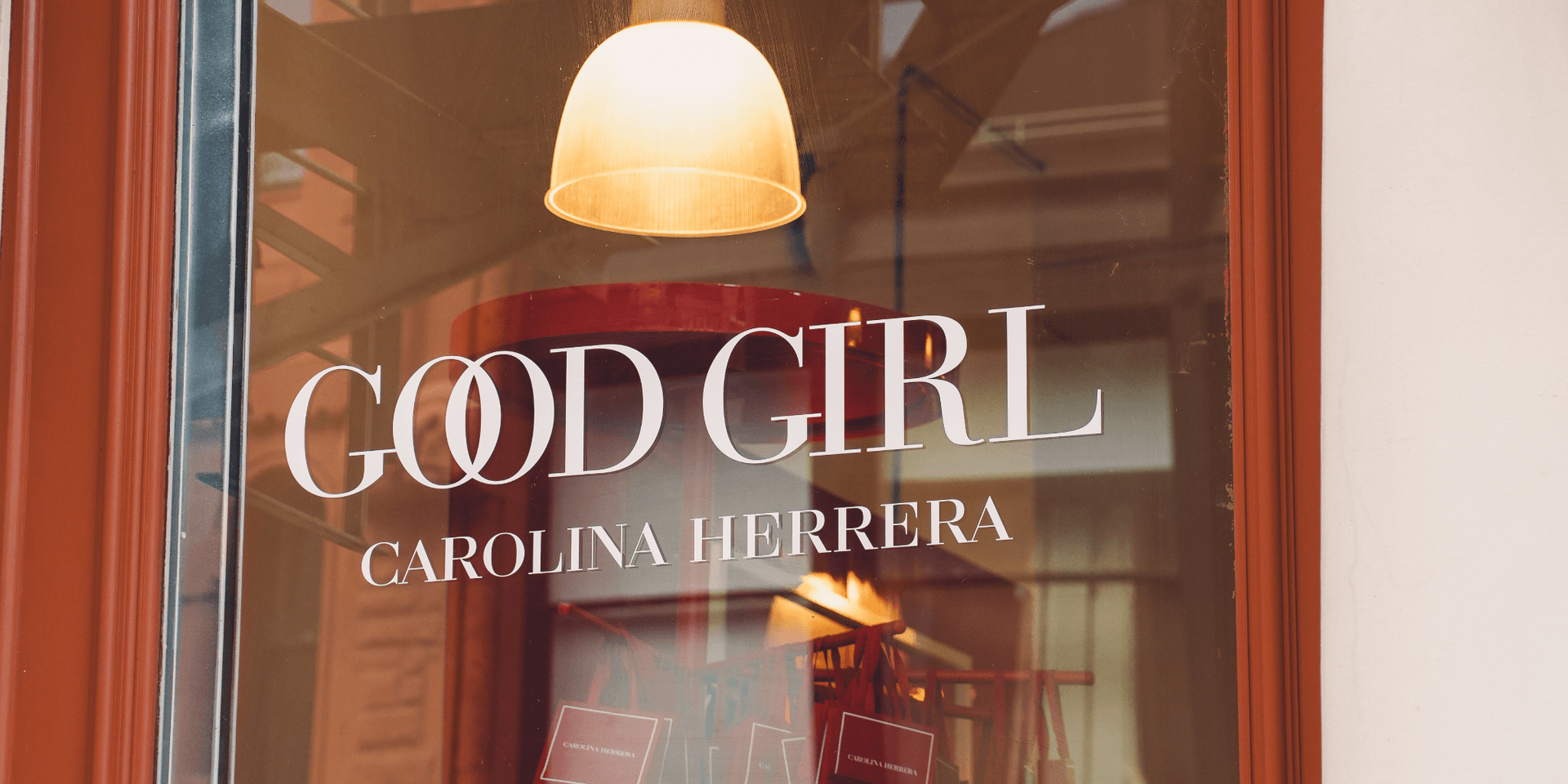Window display featuring "Good Girl" by Carolina Herrera with stylish lighting