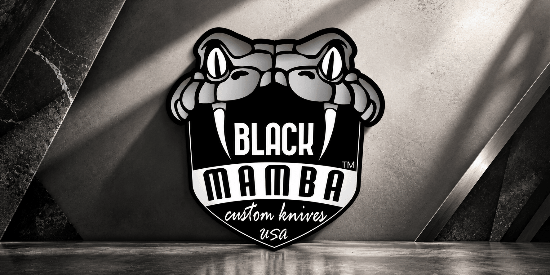Logo of Black Mamba custom knives featuring a snake design and bold typography