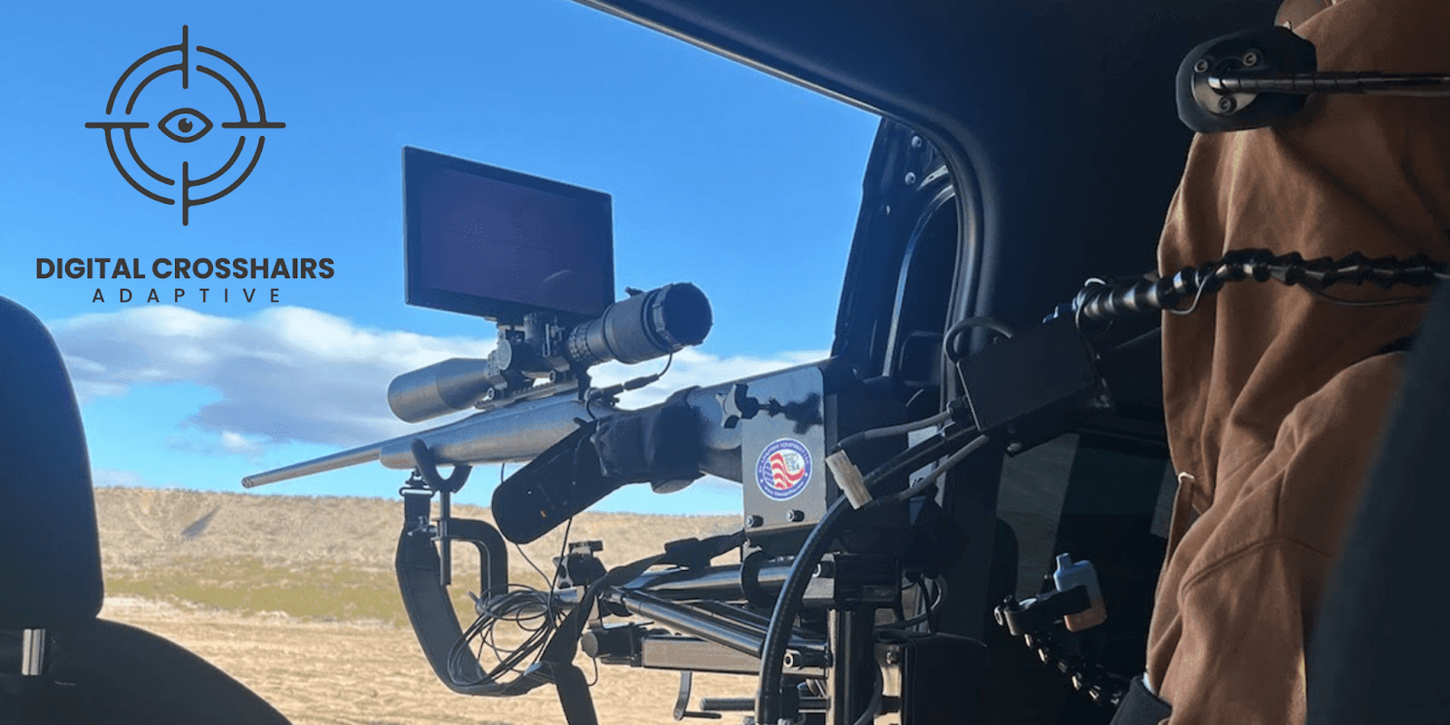 Adaptive rifle scope with digital screen setup inside a vehicle, enabling visually impaired users to aim and shoot independently.