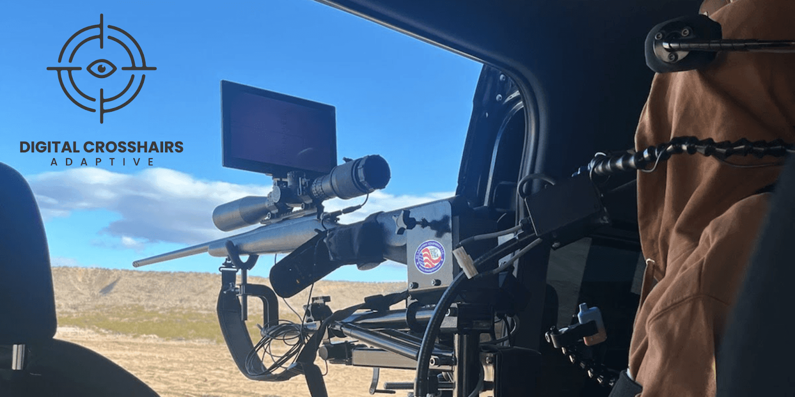 Adaptive rifle scope with digital screen setup inside a vehicle, enabling visually impaired users to aim and shoot independently.