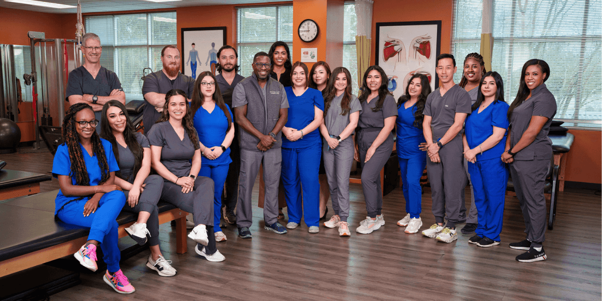 Group photo of Sterling Physical Therapy & Wellness team in clinic, showcasing diverse staff dedicated to patient recovery.