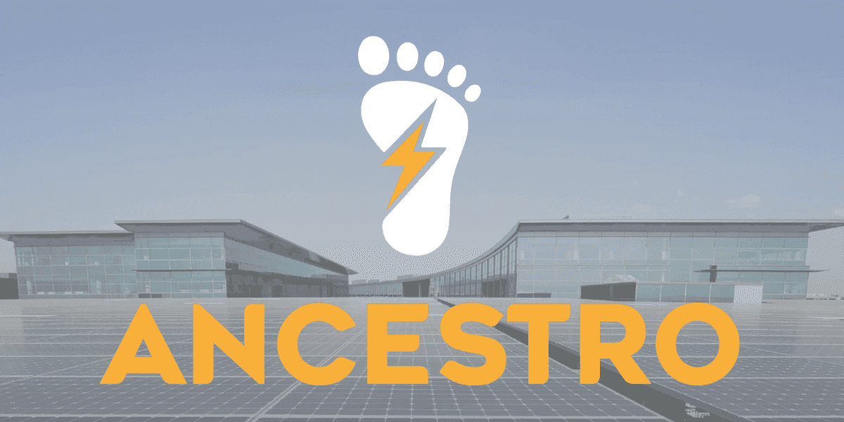 Ancestro.ai logo over solar-powered commercial buildings representing renewable energy and electric mobility infrastructure.