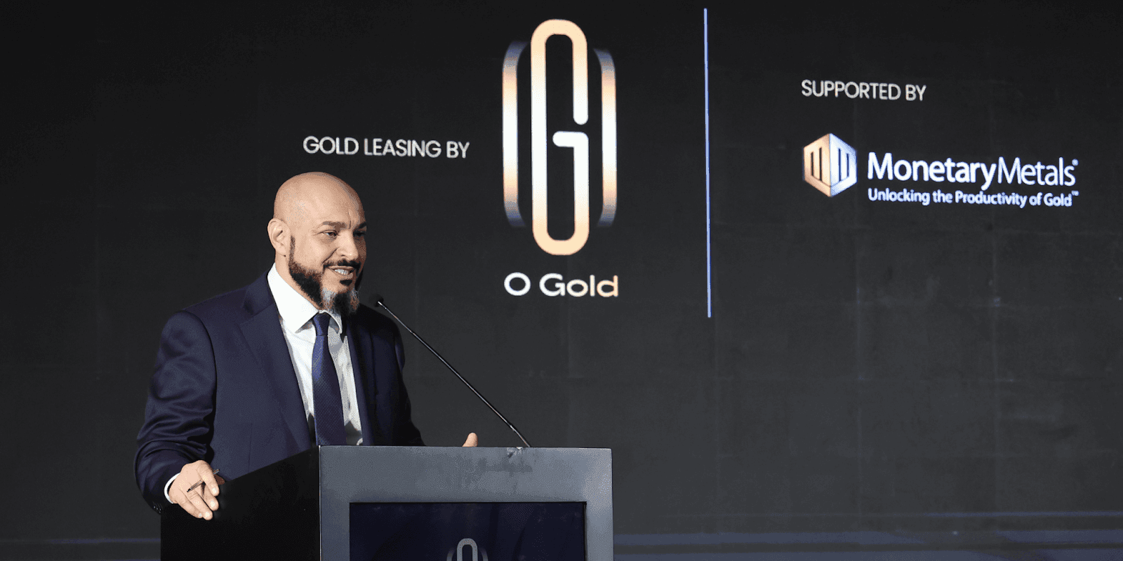 Dr. Fahmi Iskander speaks at an event, showcasing O Gold's innovative approach to accessible gold ownership and financial empowerment.
