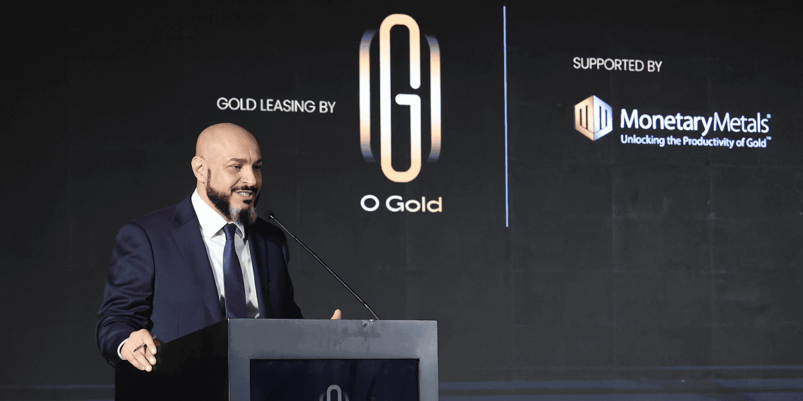 Dr. Fahmi Iskander speaks at an event, showcasing O Gold's innovative approach to accessible gold ownership and financial empowerment.