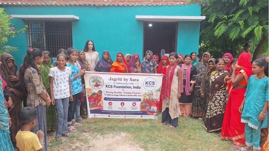 Saranya Gupta stands with women participating in the Jagriti by Sara sewing training program in Bihar.