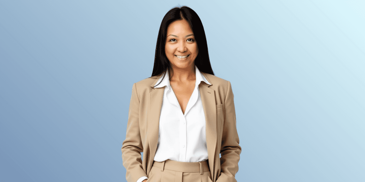 Ara Jaingue, founder of Mama Tribe United, smiling confidently in beige suit against a gradient blue background.