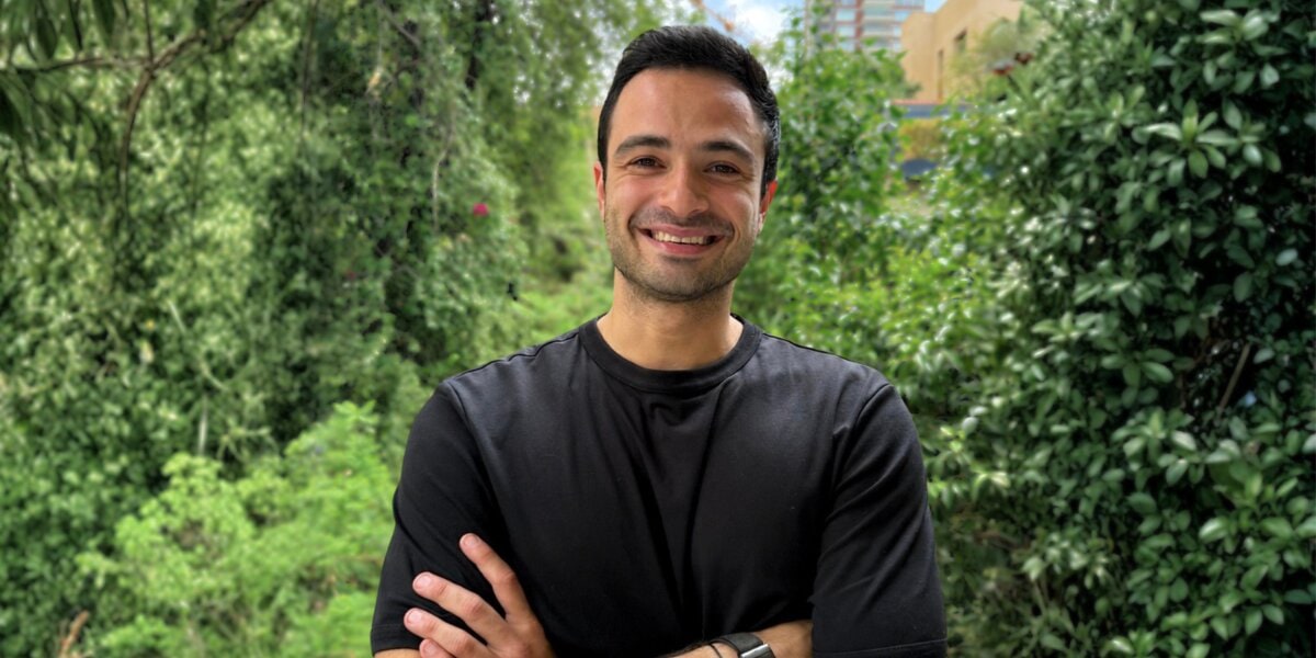 Zenith Education founder Serge Nader smiling outdoors with arms crossed.