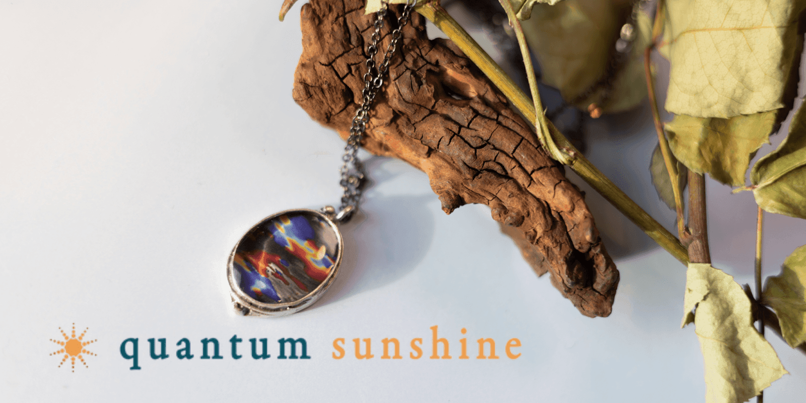 The image showcases a Quantum Sunshine pendant, blending scientific imagery and artistic design to inspire joy, connection, and healing.