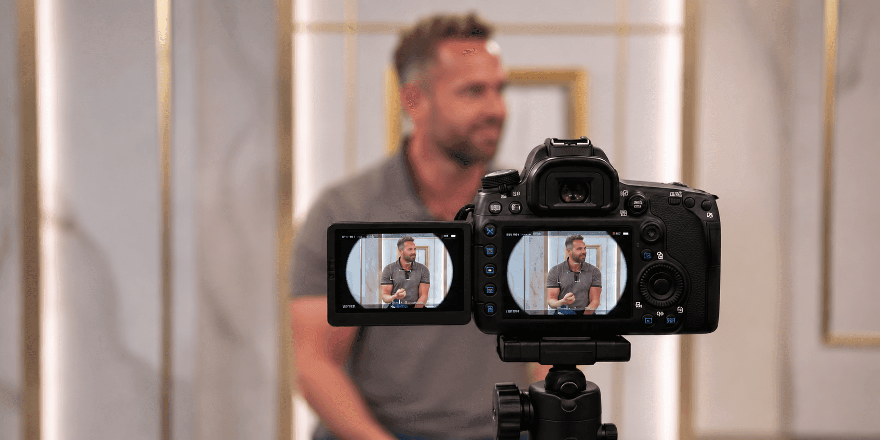 Camera filming Mike Nicholls during a studio presentation.