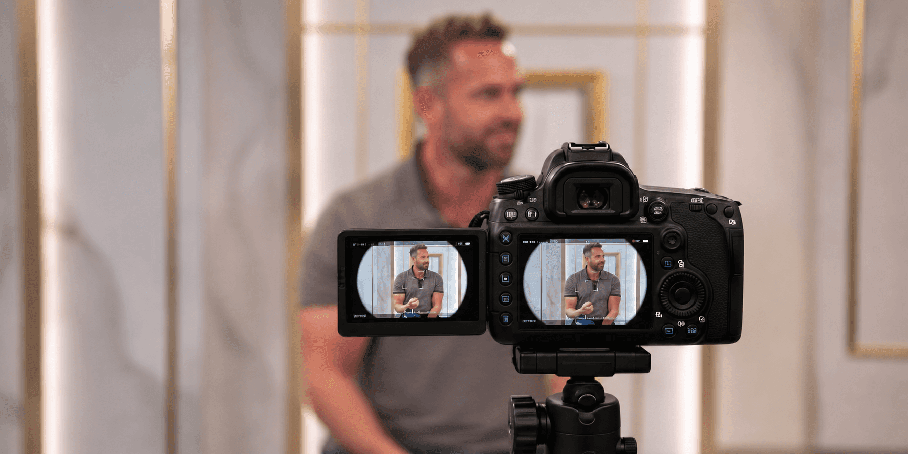 Camera filming Mike Nicholls during a studio presentation.