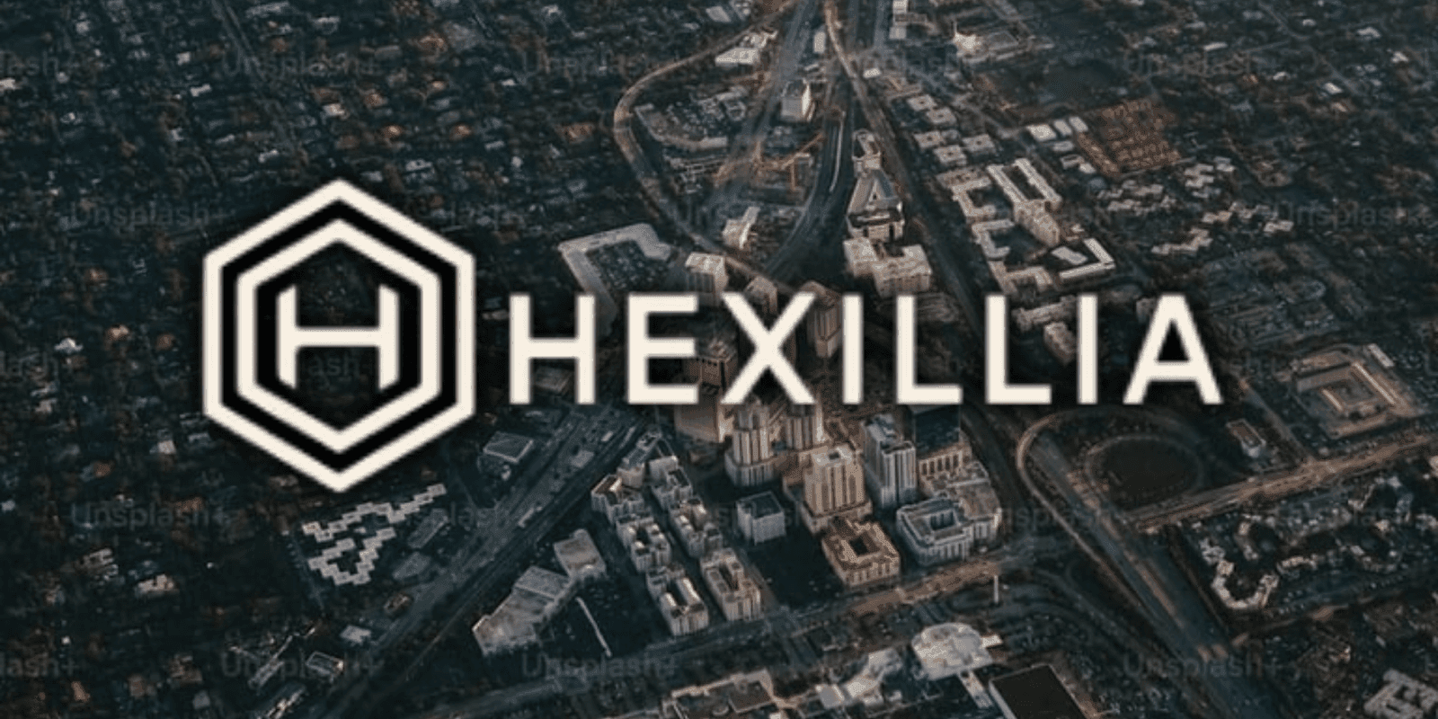 Aerial view of a city with Hexillia branding overlaid, showcasing urban landscape, roads, and buildings in soft light.