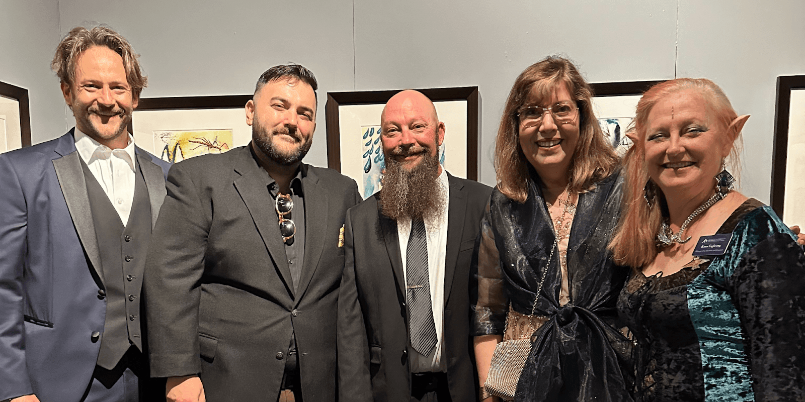 "A memorable group moment at an art exhibition, highlighting creative connections and shared joy among artists and attendees."