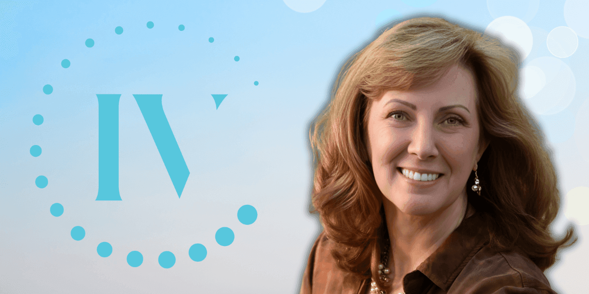 Carey Mencarini, founder of IV Lounge, smiling with the IV Lounge logo in the background, representing wellness and vitality.