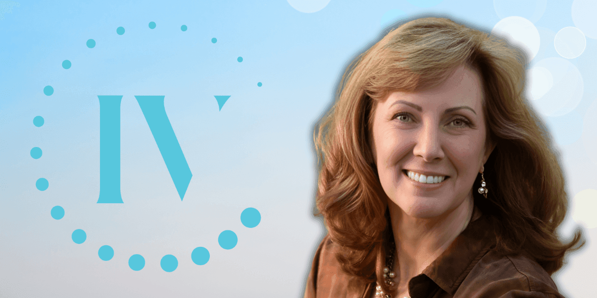 Carey Mencarini, founder of IV Lounge, smiling with the IV Lounge logo in the background, representing wellness and vitality.