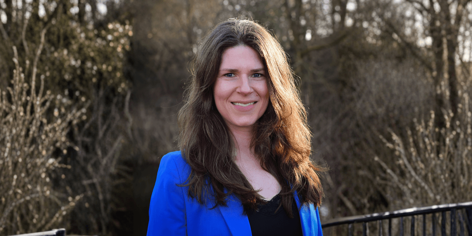 Ellen Duffy-Lueb, a women’s leadership strategist, smiling confidently in a blue blazer, advocating for burnout prevention and energy management.